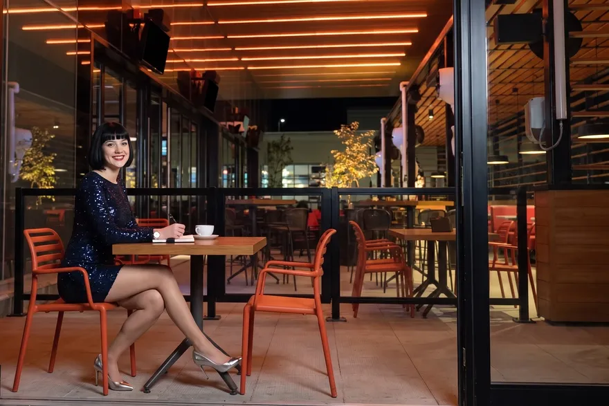 Woman writing in a notebook on the MATCH patio