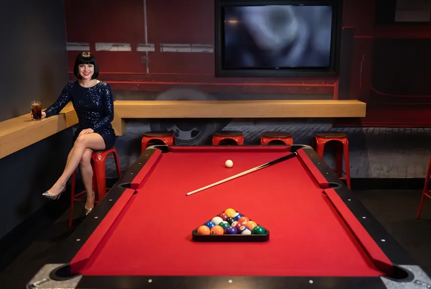 Woman by the red pool table at MATCH